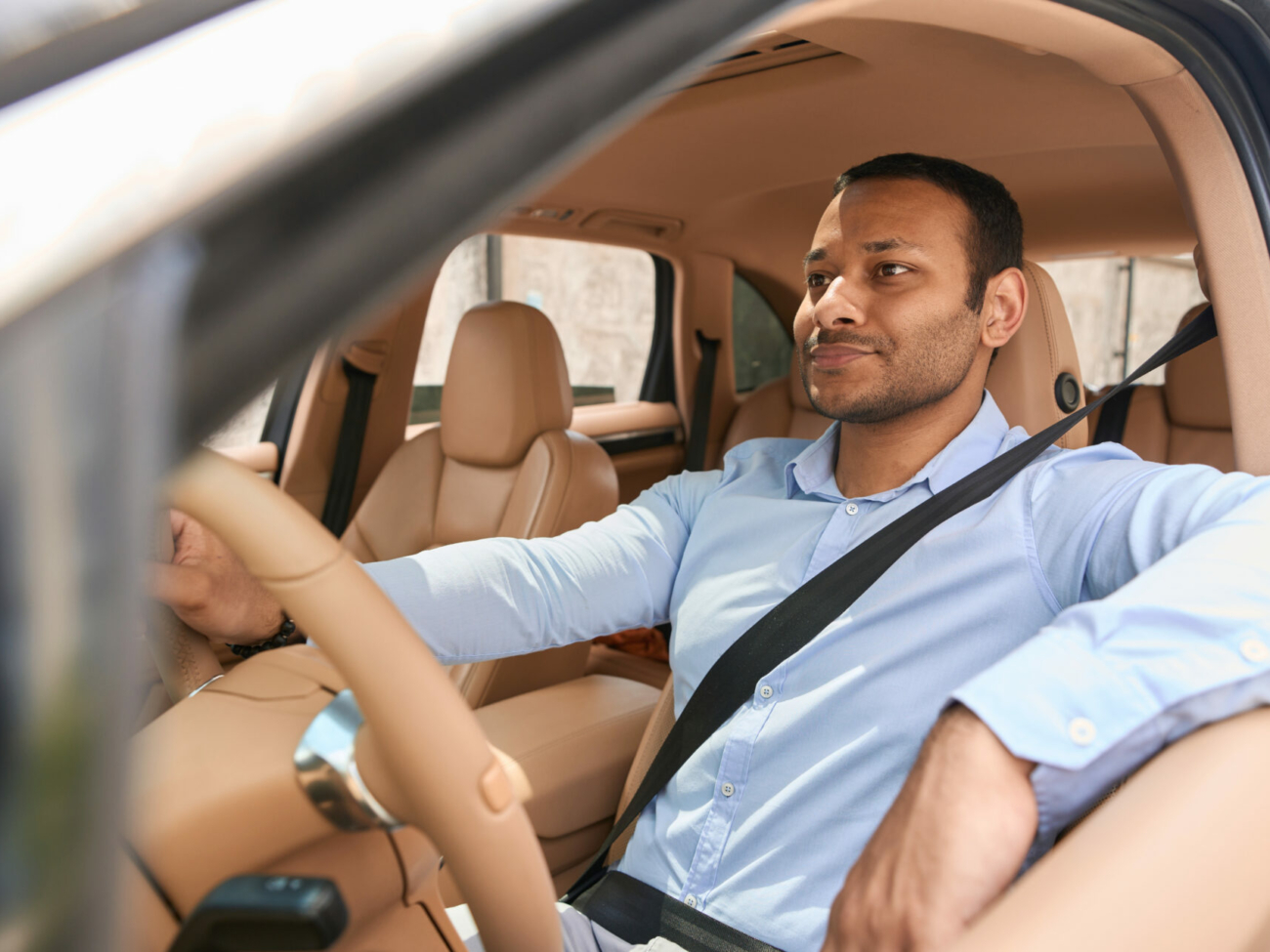 calm-driver-sitting-in-front-seat-of-automobile-fastened-with-seat-belt-stockpack-istock.jpg