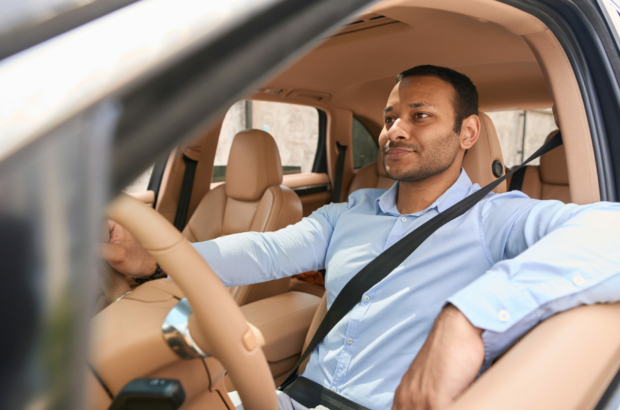 calm-driver-sitting-in-front-seat-of-automobile-fastened-with-seat-belt-stockpack-istock.jpg