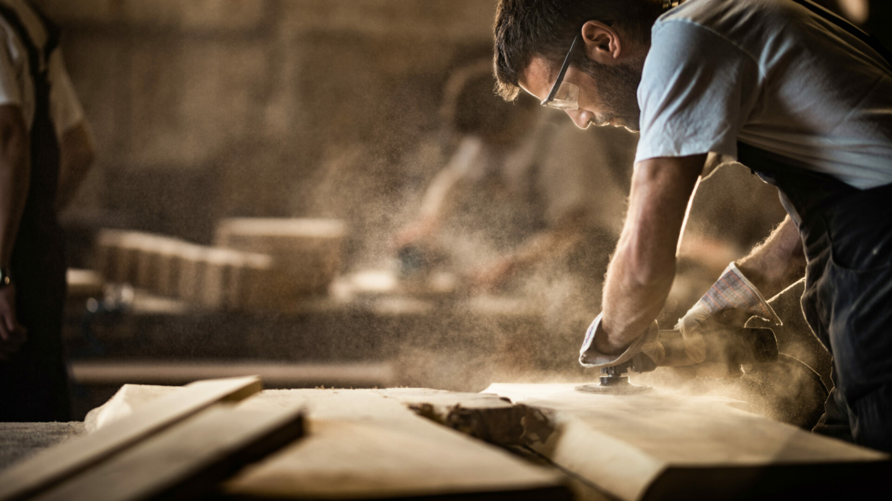 manual-worker-using-sander-while-working-on-a-wood-in-carpentry-workshop-stockpack-istock.jpg