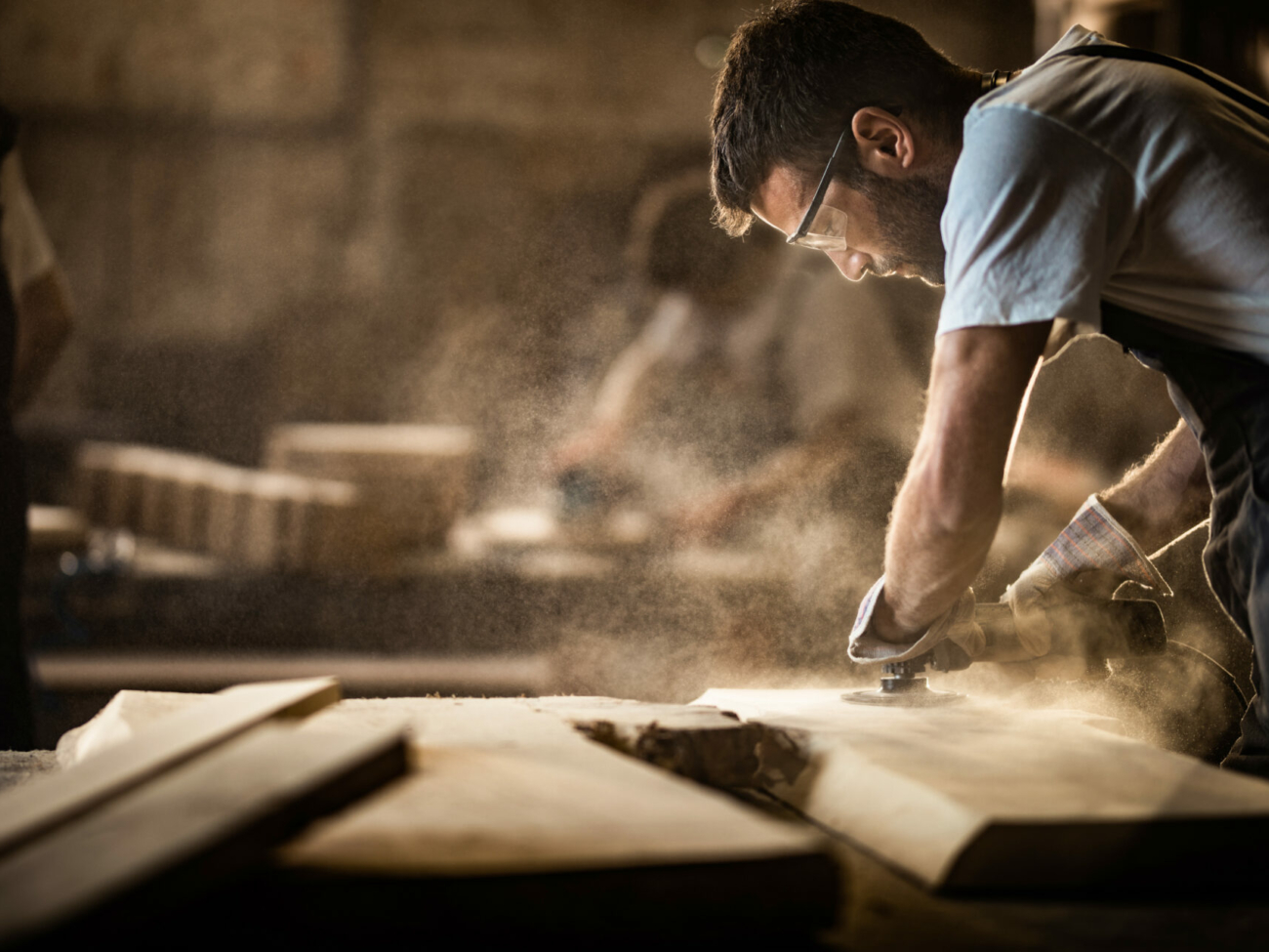 manual-worker-using-sander-while-working-on-a-wood-in-carpentry-workshop-stockpack-istock.jpg