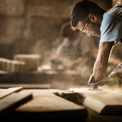 manual-worker-using-sander-while-working-on-a-wood-in-carpentry-workshop-stockpack-istock.jpg