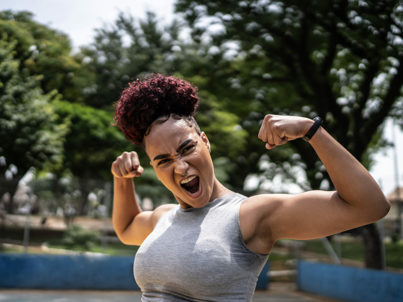 portrait-of-a-young-woman-celebrating-at-a-sports-court-stockpack-istock.jpg