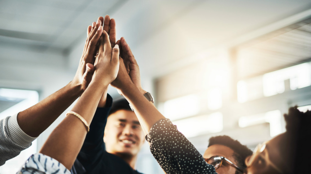 shot-of-a-group-of-unrecognizable-businesspeople-high-fiving-in-an-office-stockpack-istock.jpg