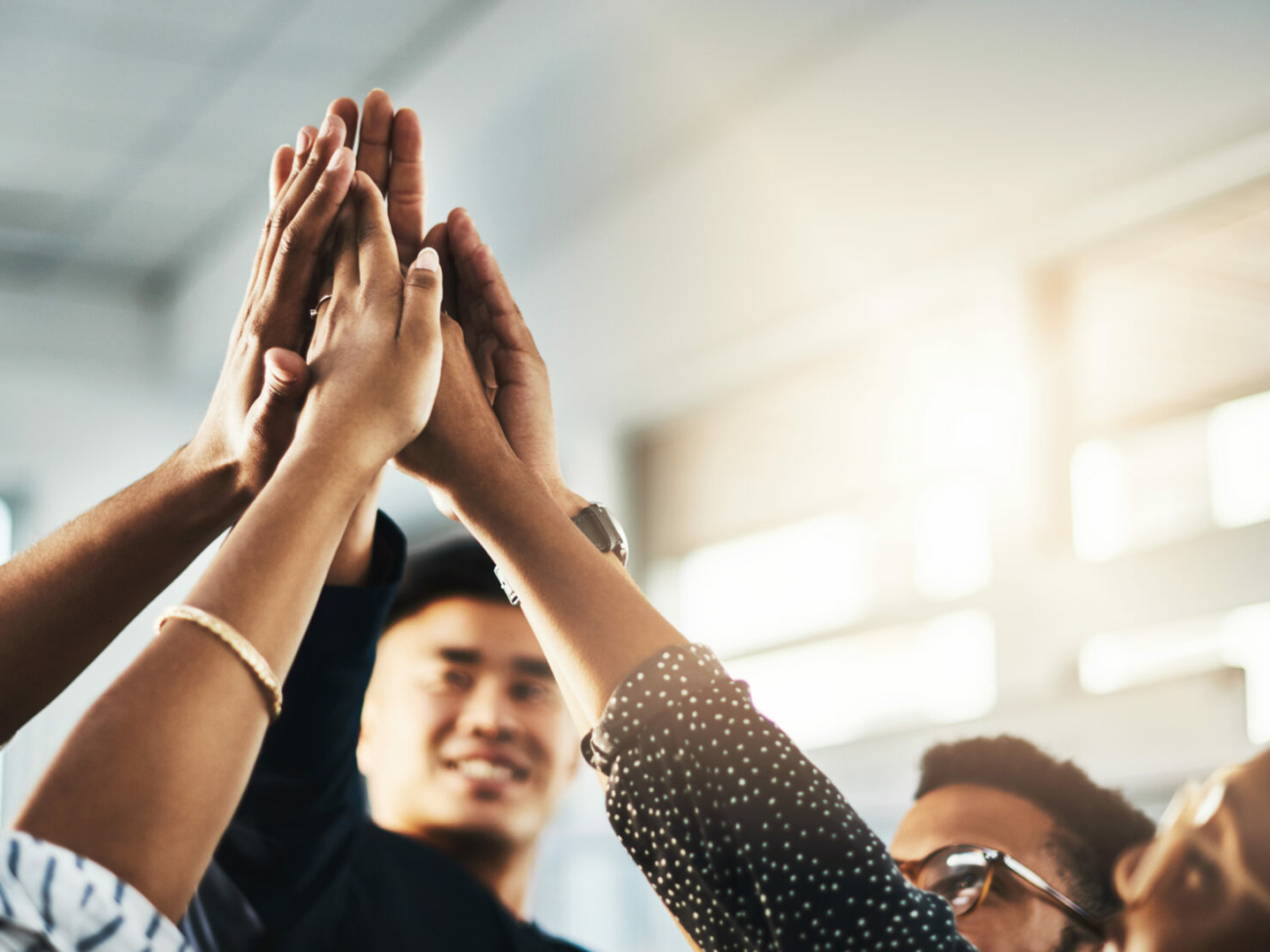 shot-of-a-group-of-unrecognizable-businesspeople-high-fiving-in-an-office-stockpack-istock.jpg