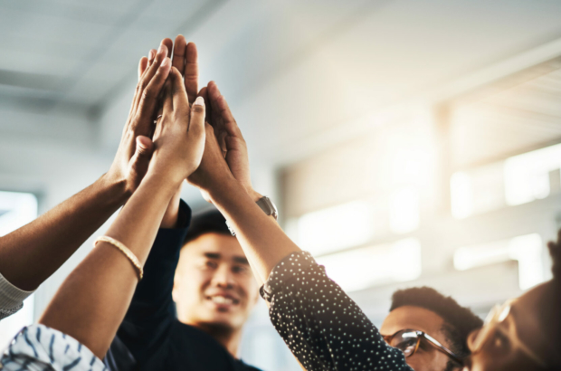 shot-of-a-group-of-unrecognizable-businesspeople-high-fiving-in-an-office-stockpack-istock.jpg