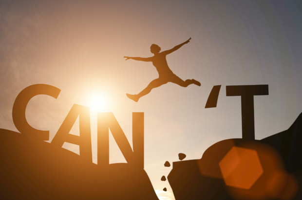 silhouette-man-jump-between-cant-wording-and-can-wording-on-mountain-mindset-for-career-growth-business-stockpack-istock.jpg