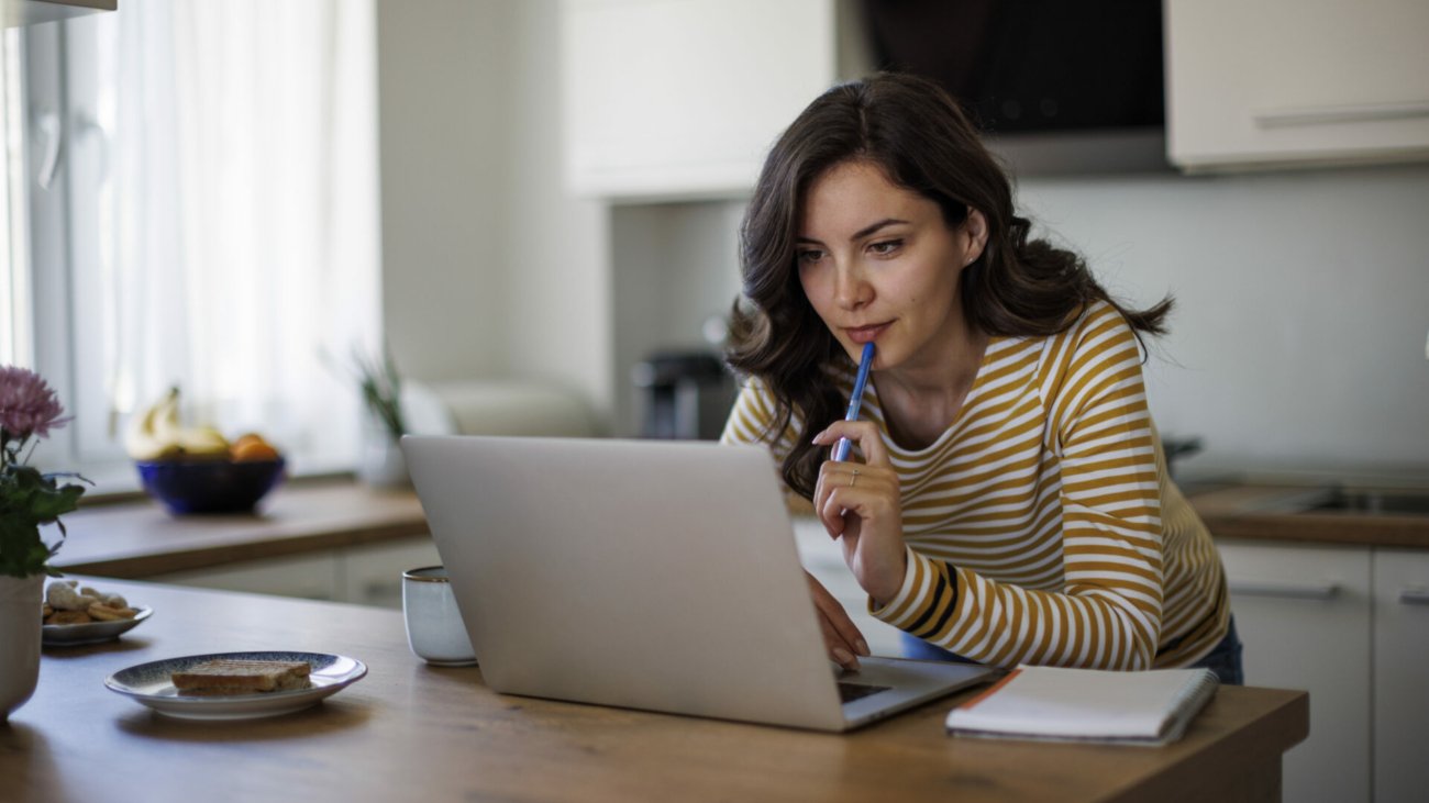 young-woman-using-a-laptop-while-working-from-home-stockpack-istock.jpg